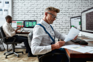 “man in office analysing reference data on securities