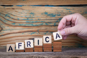a hand and the name Africa in a economic uptrend