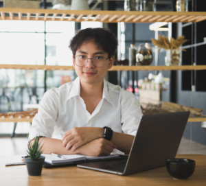 young investitor tracking corporate actions data on his lap top