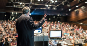 speaker addressing the audience in a corporate event